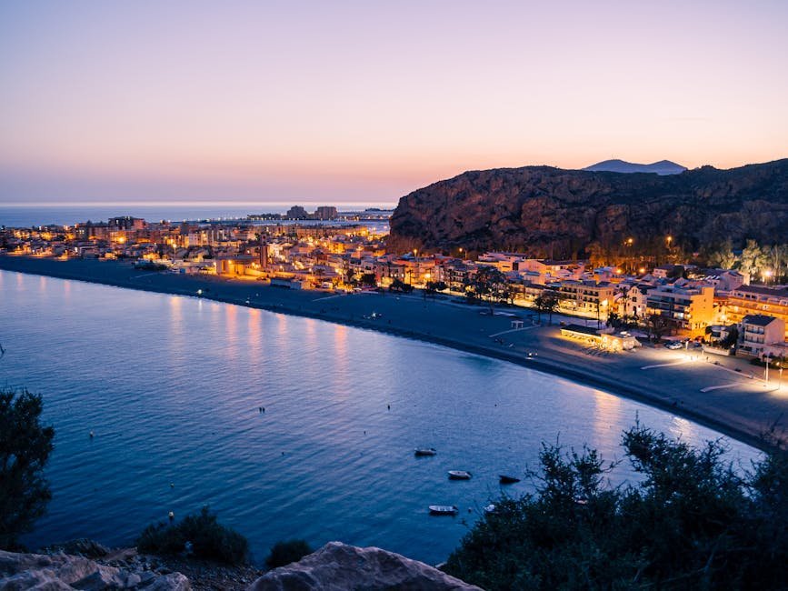 A breathtaking twilight view of Calahonda's illuminated coastline and town with a serene sea backdrop.